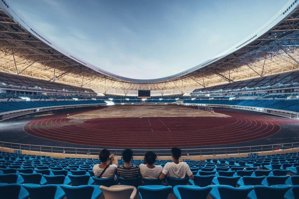 four person sitting on blue chair stadium